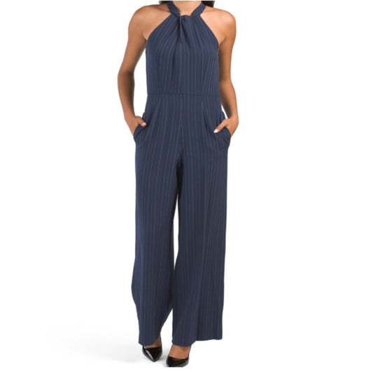 A sleeveless halter neck jumpsuit with wide legs and a striped pattern, featured in navy and ivory colors.