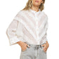 “Seashell Ruffle Joy Shirt” was made to wear as a great layering piece. Designed in a relaxed fit with round neckline with seashell button closure on front. Sewn diagonally with different types of lace trim on front and finished with 3/4 sleeve with button closure on sleeve band.
