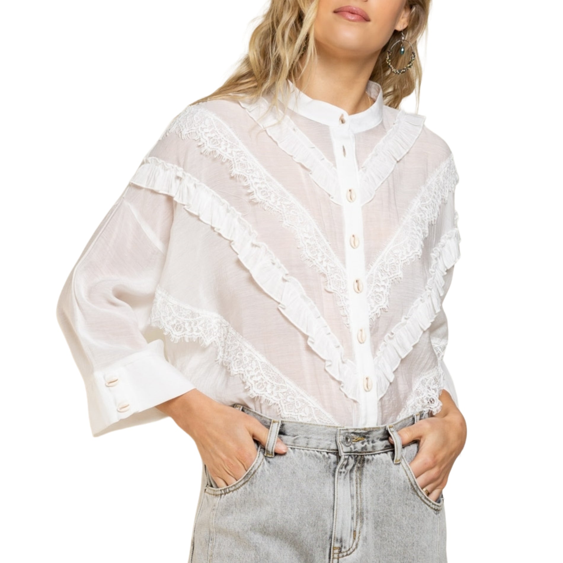 “Seashell Ruffle Joy Shirt” was made to wear as a great layering piece. Designed in a relaxed fit with round neckline with seashell button closure on front. Sewn diagonally with different types of lace trim on front and finished with 3/4 sleeve with button closure on sleeve band.